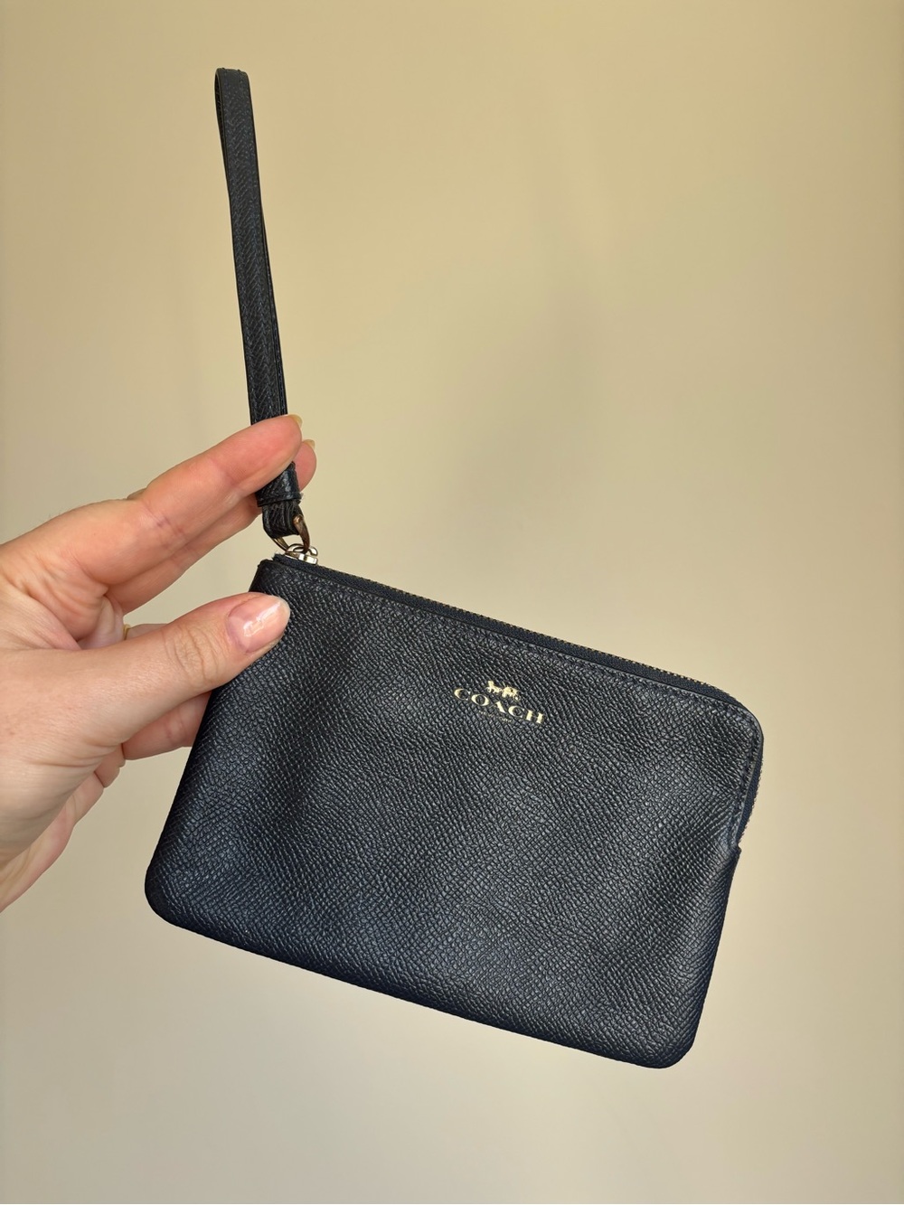 Coach black pebbled leather corner zip wristlet with gold tone hardware